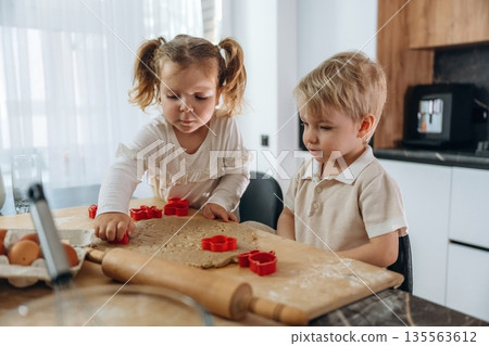 Kids are preparing bakery at home Kids are preparing bakery at home 135563612