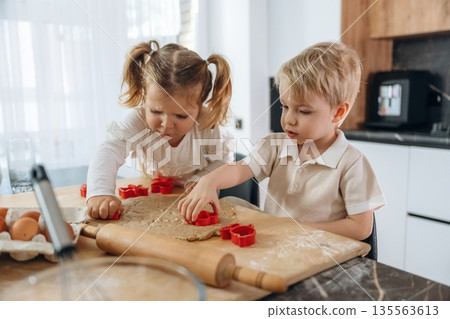 Kids are preparing bakery at home Kids are preparing bakery at home 135563613