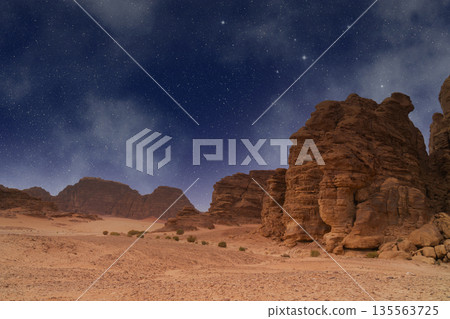 Wadi Rum desert. Valley of the Moon landscape under night sky with stars and rock formations Wadi Rum desert. Valley of the Moon landscape under night sky with stars and rock formations 135563725