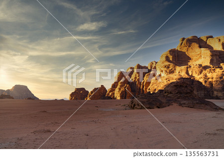 Wadi Rum desert, Jordan, The Valley of the Moon. Landscape with rocks and mountains at sunset. Wadi Rum desert, Jordan, The Valley of the Moon. Landscape with rocks and mountains at sunset. 135563731