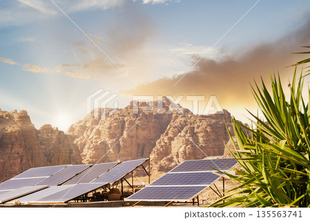 Solar panels on mountain landscape at sunset in a desert location with clear skies. Petra, Jordan. Solar panels on mountain landscape at sunset in a desert location with clear skies. Petra, Jordan. 135563741