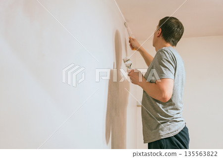 Man painting walls Man painting walls 135563822