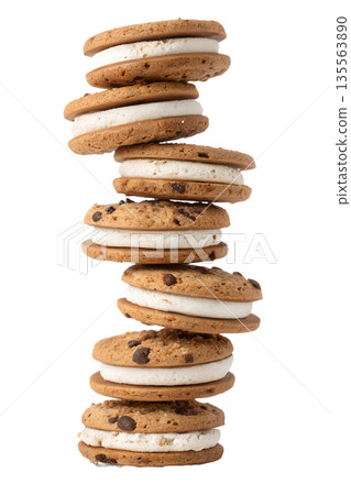 Tall, vertical stack of classic chocolate chip cookie sandwiches with creamy vanilla filling, isolated. Sweet treat for indulgence and desserts Tall, vertical stack of classic chocolate chip cookie sandwiches with creamy vanilla filling, isolated. Sweet treat for indulgence and desserts 135563890