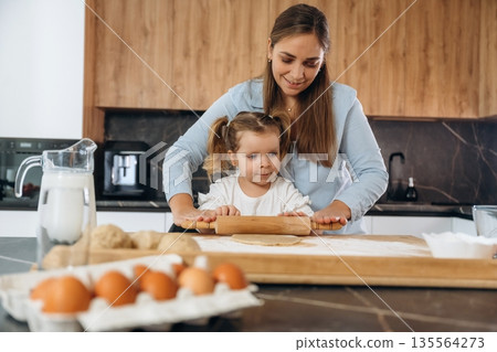 Bunch of eggs. Mother and daughter are cooking on the kitchen Bunch of eggs. Mother and daughter are cooking on the kitchen 135564273