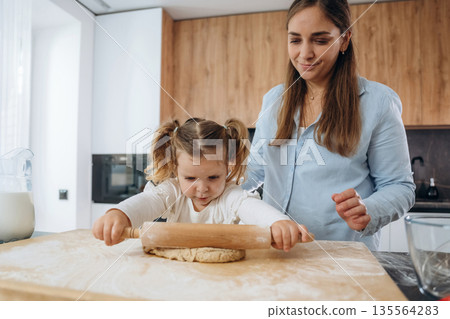 Two people. Mother and daughter are cooking on the kitchen 135564283