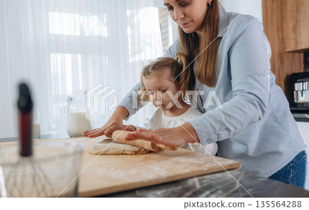 Two people. Mother and daughter are cooking on the kitchen 135564288