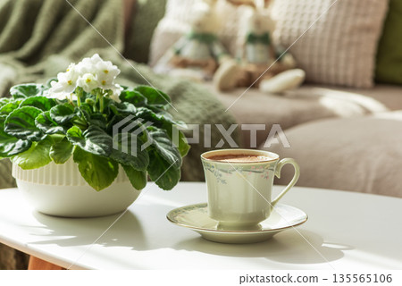 Cozy Easter Living Room with Plush Bunnies, Coffee and Flowers in Sunlight Cozy Easter Living Room with Plush Bunnies, Coffee and Flowers in Sunlight 135565106