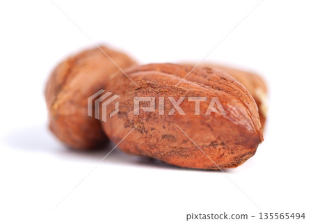 Hazelnuts kernels on a white background, healthy food. Macro Hazelnuts kernels on a white background, healthy food. Macro 135565494