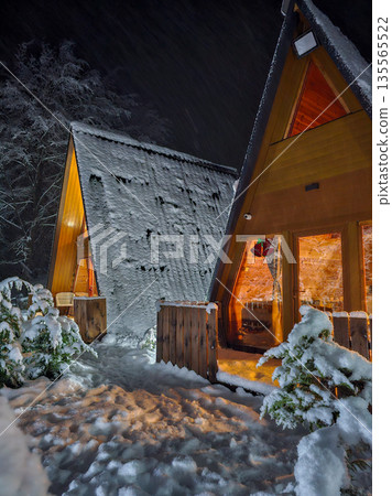Two A Frame Eco Cabins at Night in Snowy Forest 135565522
