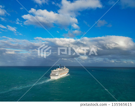 Miami, Florida, USA - December 13, 2024: Cruise in summer vacation. Carnival Cruise line. Cruise ship tour and travel at ocean. Ship leaving Miami beach port. Carnival Conquest cruise ship voyage 135565615