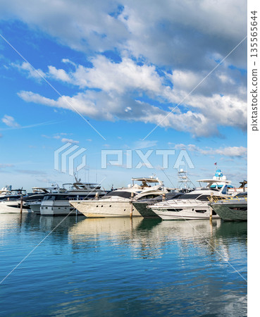 Motorboat yacht sailing at sea. Yachting boat tourism. Motorboat sea marina. Luxury yacht marina. Docked luxurious yacht boat. Luxury lifestyle. Motorboat at sea. Summer vacation. Yachts in sunny bay 135565644