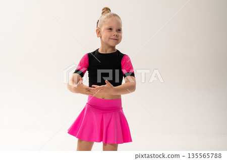 Young dancer with cochlear implant extending arms gracefully. Copy space. Expression of inclusion, sound awareness, and emotional freedom through art and rhythmic discipline. 135565788