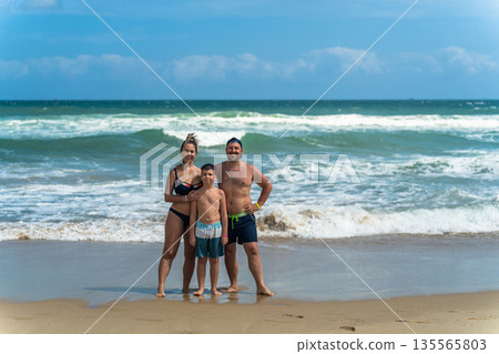 Beautiful young family on vacation at sea Beautiful young family on vacation at sea 135565803