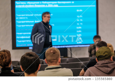 Business presentation in conference room with speaker and attentive audience during seminar Business presentation in conference room with speaker and attentive audience during seminar 135565860