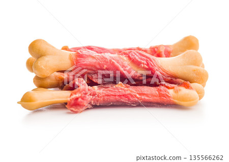 Dog food. Snack sticks for dogs isolated on white background. 135566262