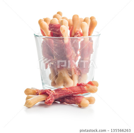 Dog food. Snack sticks for dogs isolated on white background. 135566263