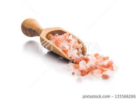 Pink Himalayan salt on wooden scoop isolated on white background. Pink Himalayan salt on wooden scoop isolated on white background. 135566266