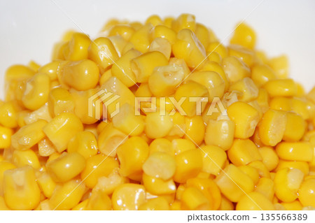 Grains of canned yellow corn close up on white background Grains of canned yellow corn close up on white background 135566389