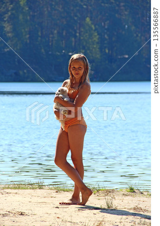 Little girl posing for photo with her small Multipoo dog. Spring feeling Little girl posing for photo with her small Multipoo dog. Spring feeling 135566887