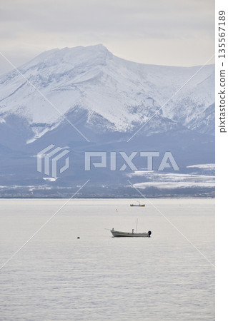 Photographed a winter scene of snow-capped Mount Komagatake and fishing boats in Yakumo, Hokkaido. Photographed a winter scene of snow-capped Mount Komagatake and fishing boats in Yakumo, Hokkaido. 135567189
