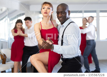 Adult man and adult woman dance tango 135567228