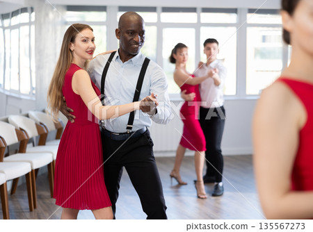 Adult man and young woman dancing waltz Adult man and young woman dancing waltz 135567273