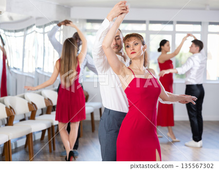 Adult man and adult woman dance tango Adult man and adult woman dance tango 135567302