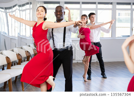 Adult man and young woman dance tango 135567304