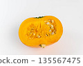 Halved orange pumpkin with visible seeds and fibrous interior on a white background, showcasing the vibrant color and texture of the fruit for culinary or decorative use 135567475