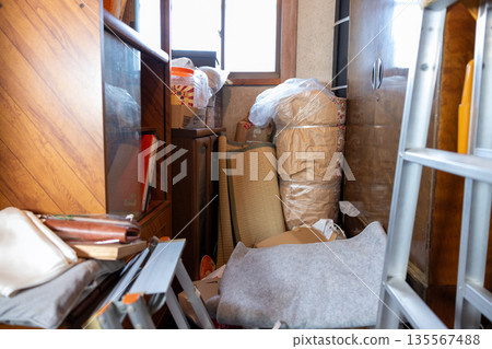A storeroom in an old house overflowing with things A storeroom in an old house overflowing with things 135567488