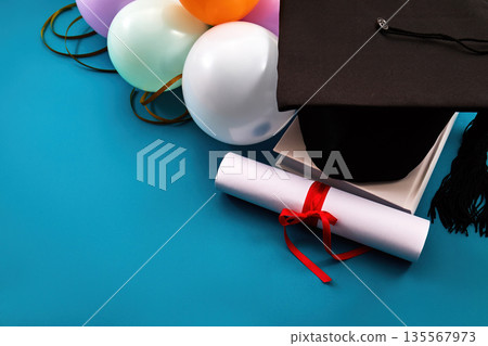 Graduation cap diploma and balloons celebrating academic success Graduation cap diploma and balloons celebrating academic success 135567973