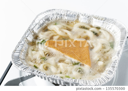 Kitsune udon cooked in a square aluminum container Kitsune udon cooked in a square aluminum container 135570300
