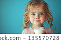 Kid girl holding glass of milk 135570728