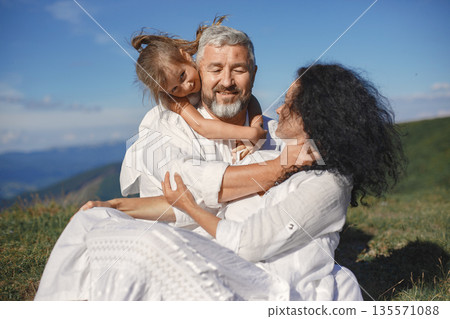 People in a mountain. Grandparents with grandchildren. Woman in a white dress. People in a mountain. Grandparents with grandchildren. Woman in a white dress. 135571088