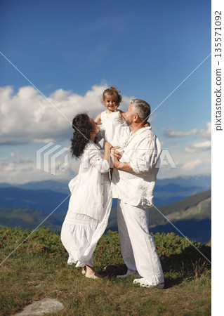 People in a mountain. Grandparents with grandchildren. Woman in a white dress. People in a mountain. Grandparents with grandchildren. Woman in a white dress. 135571092