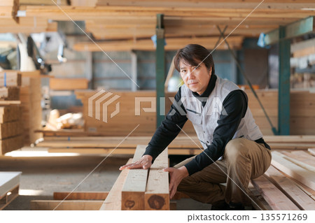 Man working at a lumber mill Man working at a lumber mill 135571269