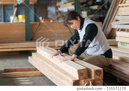 Man working at a lumber mill Man working at a lumber mill 135571270