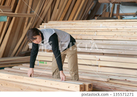 Man working at a lumber mill Man working at a lumber mill 135571271