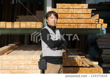 Man working at a lumber mill Man working at a lumber mill 135571634