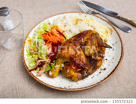 Delicious chicken dish with salad and rice 135572323