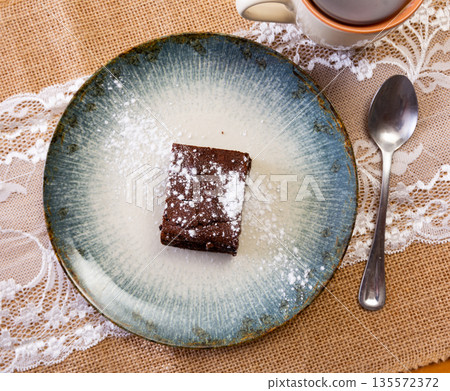 Chocolate brownie cake served for dessert 135572372