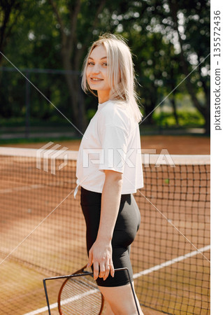 Tennis player going through tennis curt. Model posing. Hobbies, sports, equipment. Tennis player going through tennis curt. Model posing. Hobbies, sports, equipment. 135572436