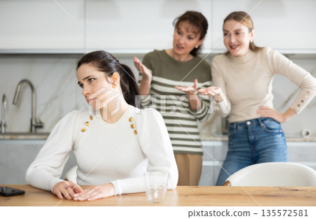 Two sisters during family quarrel accuse woman Two sisters during family quarrel accuse woman 135572581
