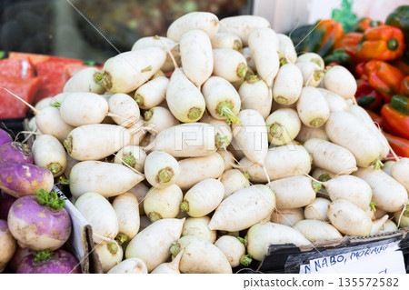 Basket filled with ripe turnips on display at market. Shoppers are offered fruits and vegetables from around world 135572582