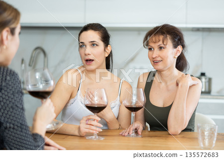 Three women have nice chat-in with wine and conversation 135572683