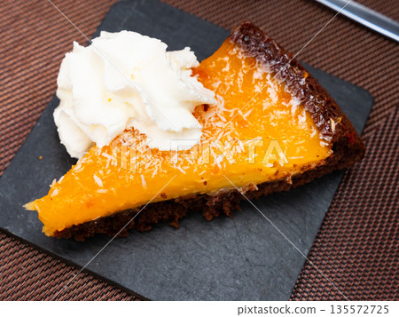 Slice of orange cake served for dessert 135572725