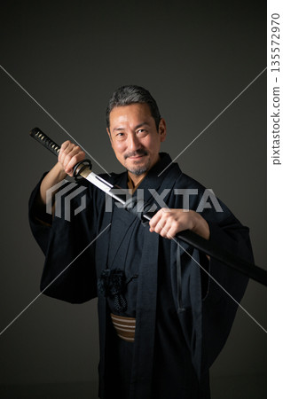 A man wearing a kimono A man wearing a kimono 135572970