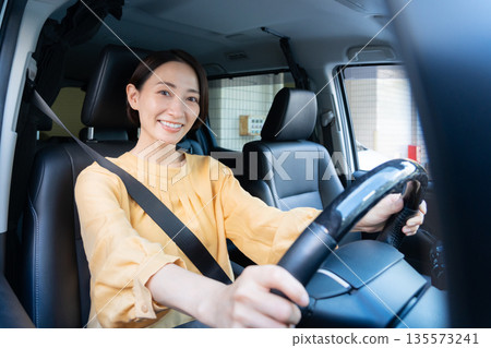 Middle-aged woman driving a car Middle-aged woman driving a car 135573241