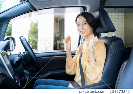 Middle-aged woman driving a car Middle-aged woman driving a car 135573243
