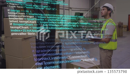 Scanning boxes on tablet in warehouse with code overlay, wearing safety vest, hard hat, copy space 135573798